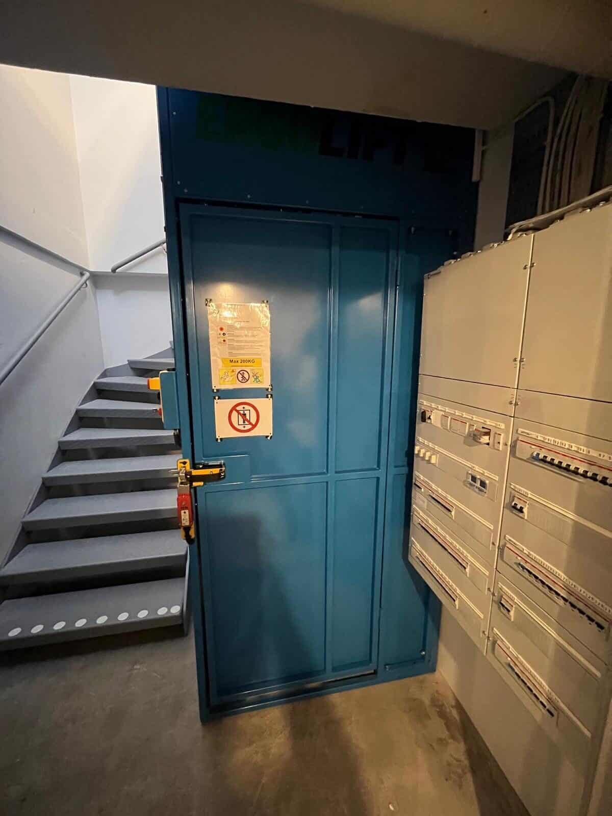 Stĺpikový výťah na spodnej zarážke s plechovými dverami